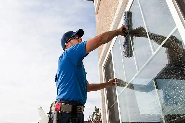 Man cleaning window